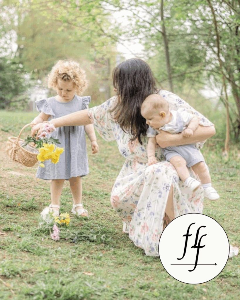 Mother kneeling with toddler and baby during a soft, natural light outdoor motherhood session in Northern New Jersey. Captured by Angela Beth Studio and featured in a nationally recognized magazine.